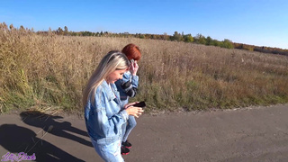 Две девушки играют с вибраторами на публике